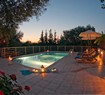 Swimming pool with candle light at dusk